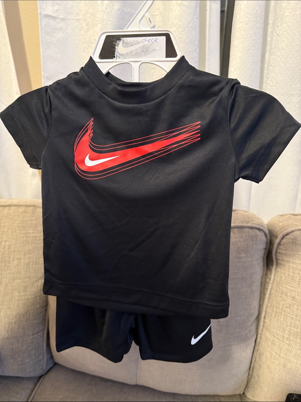 Nike Black Short Sleeve Tee with Red Swoosh Graphic